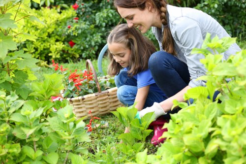 A gardener using safe practices while maintaining a garden